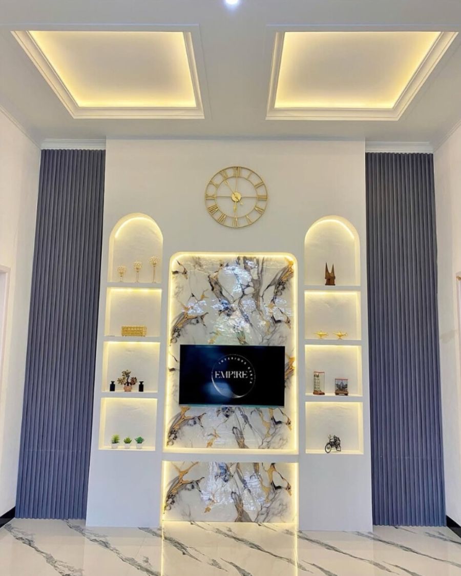Marble feature wall with arched lit shelves and cove ceiling