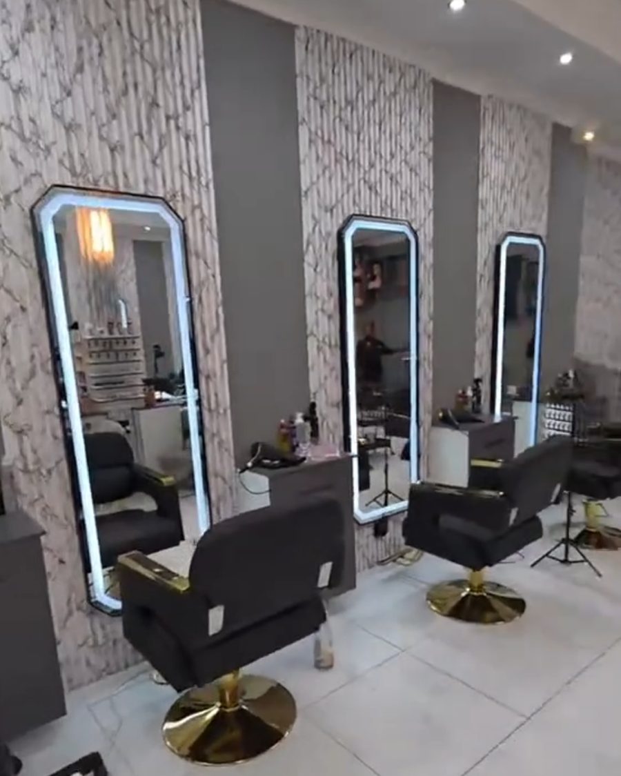 Renovated salon with feature walls and lit mirrors